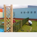 Painting fence round the raised beds